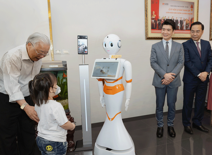 Khách hàng nhỏ vui vẻ và háo hức khi được giao tiếp với Robot thông minh
