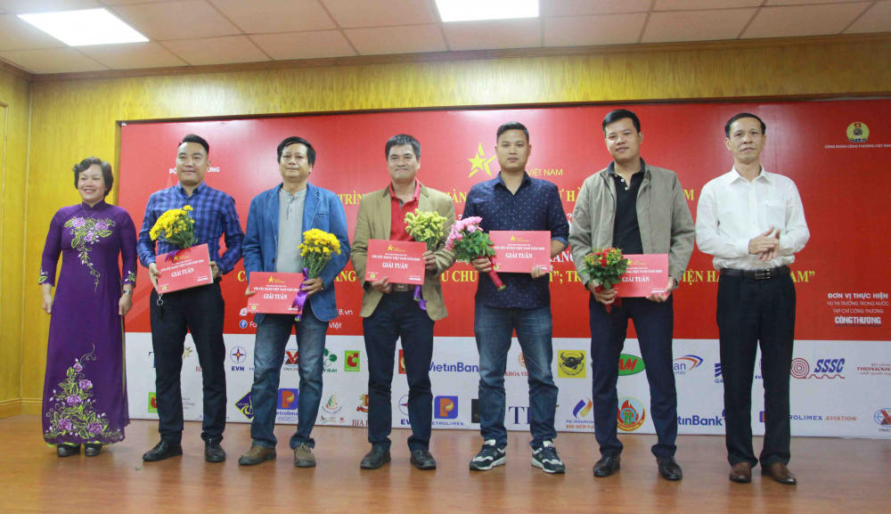Phó Chủ tịch CĐCTVN Vũ Trung Sơn và Phó Vụ trưởng Vụ Thị trường trong nước Lê Việt Nga trao giấy chứng nhận và quà cho các tác giả có tác phẩm đoạt giải trong Hoạt động bình chọn ảnh Tôi yêu hàng Việt Nam năm 2018 